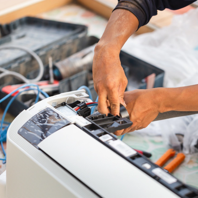 worker with some tools adjusting and fixing an ac